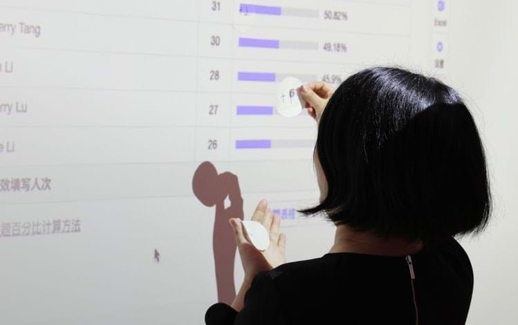Employee interacting with projector screen