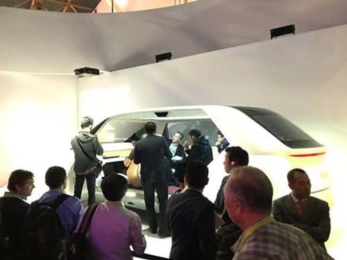 People crowd around car at CES