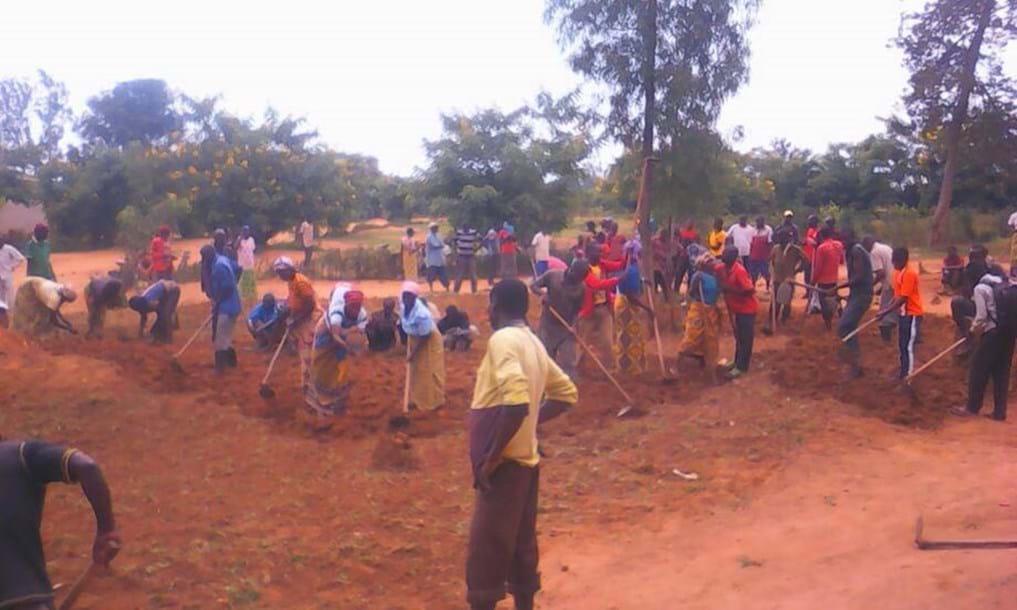 people-plowing-a-field-in-Rwanda-Africa
