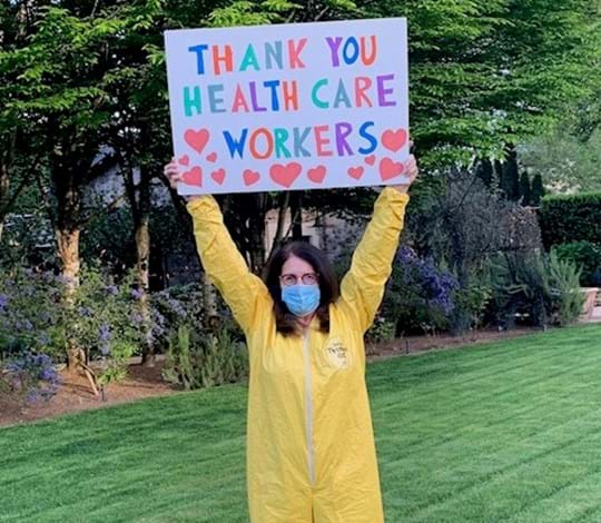 Melissa Waggener Zorking Thanks Healthcare Workers with large sign